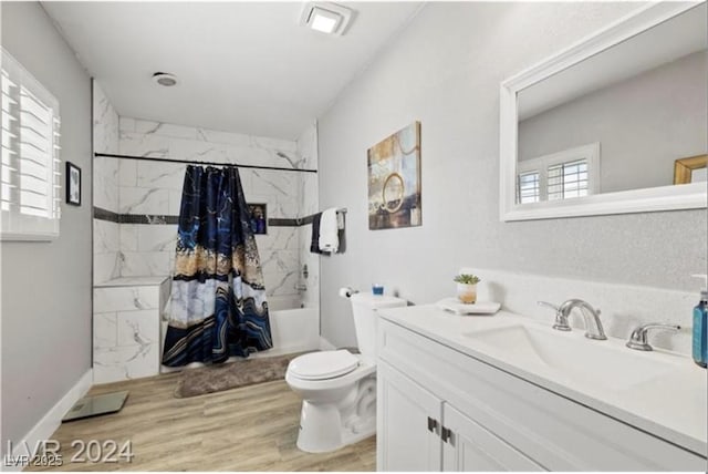 full bathroom featuring vanity, hardwood / wood-style flooring, toilet, and shower / bathtub combination with curtain