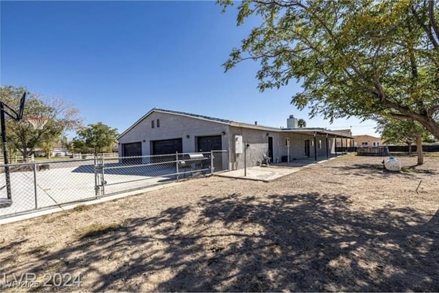 back of property featuring a garage