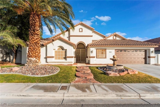 mediterranean / spanish house featuring a garage