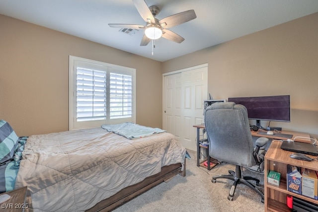 carpeted bedroom featuring ceiling fan and a closet