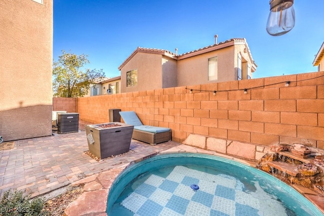 view of swimming pool featuring an outdoor fire pit, cooling unit, and a patio