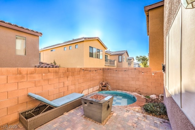 view of patio featuring an outdoor fire pit