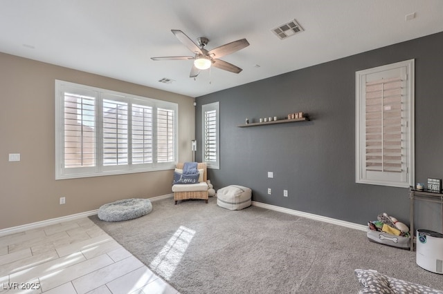 living area featuring ceiling fan and light tile patterned floors