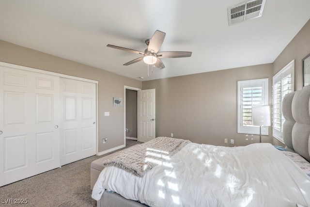 carpeted bedroom with ceiling fan and a closet