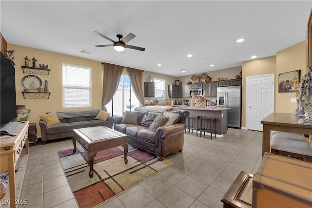 living room with ceiling fan and light tile patterned floors