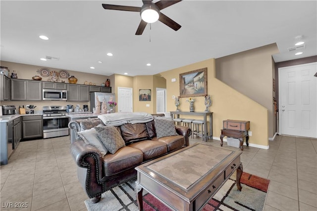 living room featuring ceiling fan and light tile patterned floors