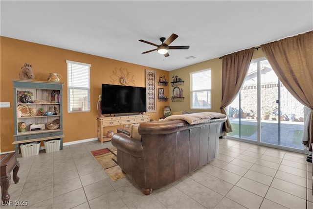 living room featuring ceiling fan and light tile patterned floors