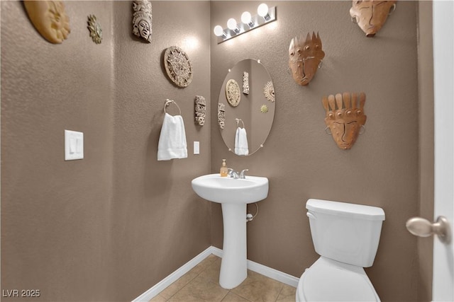 bathroom featuring toilet and tile patterned flooring