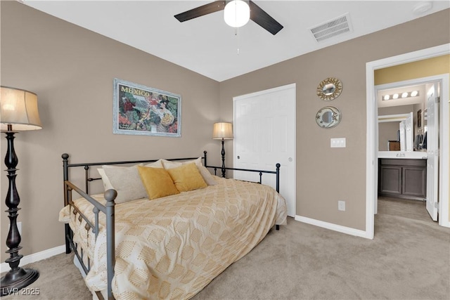 carpeted bedroom featuring ceiling fan and connected bathroom