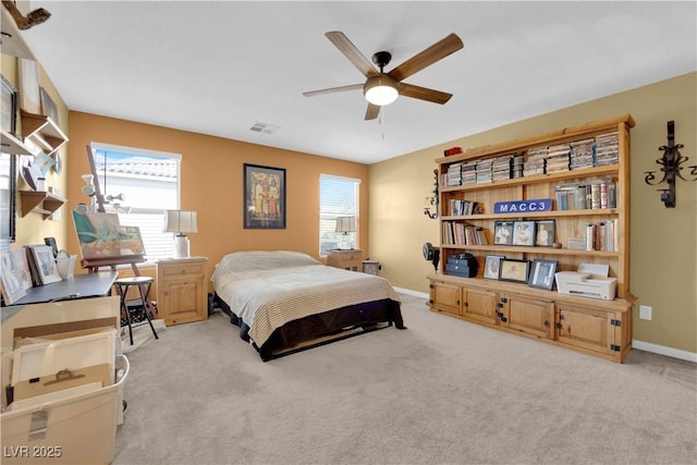 carpeted bedroom with ceiling fan and multiple windows