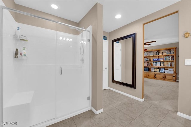 bathroom featuring ceiling fan, tile patterned floors, and a shower with door