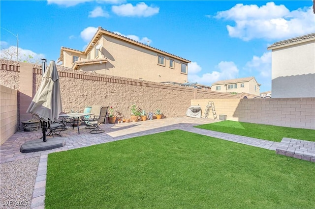 rear view of house with a yard and a patio