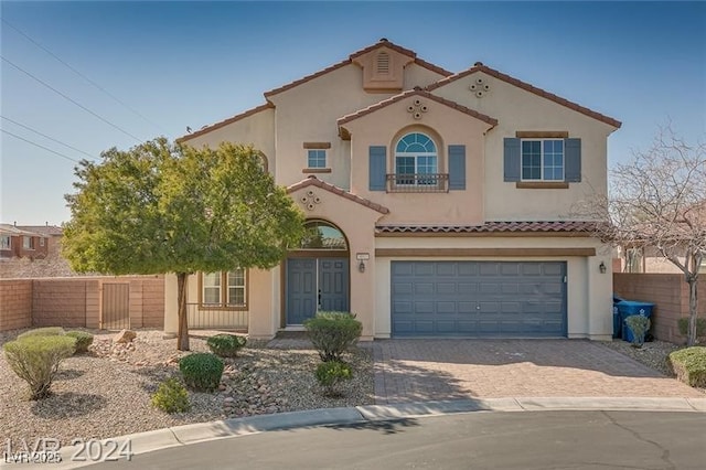 mediterranean / spanish-style house with a garage