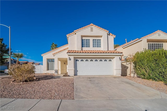 mediterranean / spanish-style house with a garage