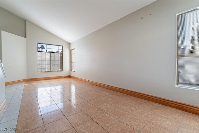 tiled empty room with vaulted ceiling