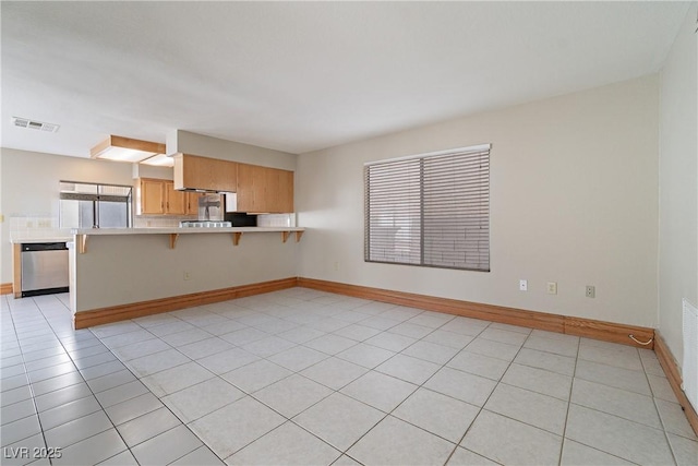 unfurnished living room featuring light tile patterned flooring