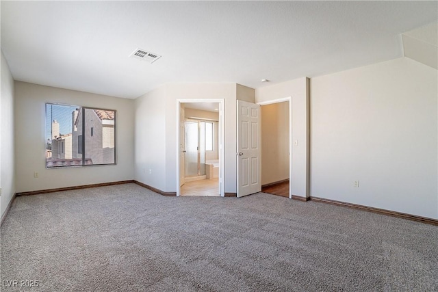 unfurnished room with light colored carpet and a wealth of natural light