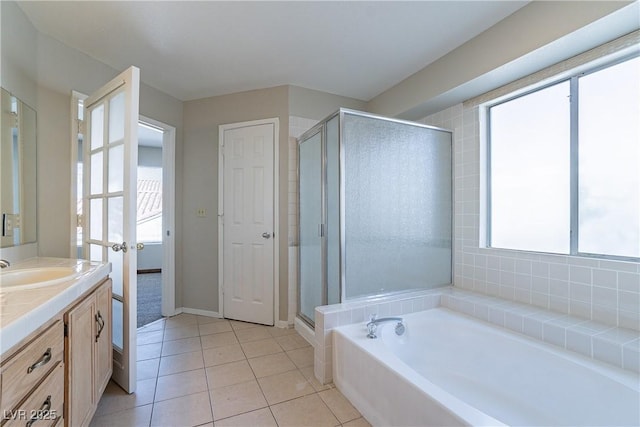 bathroom featuring separate shower and tub, vanity, and tile patterned floors