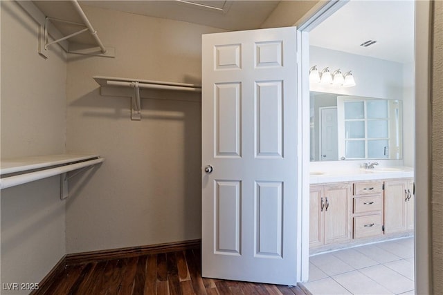 spacious closet featuring hardwood / wood-style flooring and sink