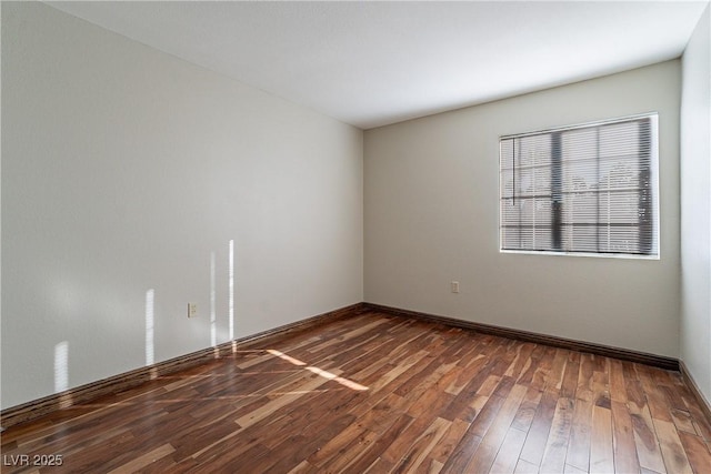 spare room with dark wood-type flooring