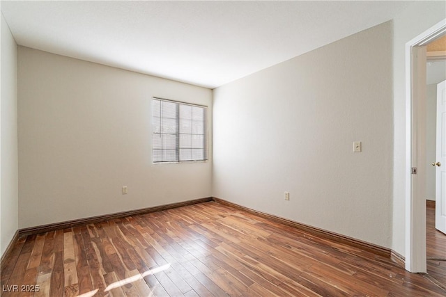 unfurnished room with wood-type flooring