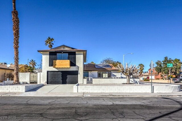 view of front of home with a garage and solar panels