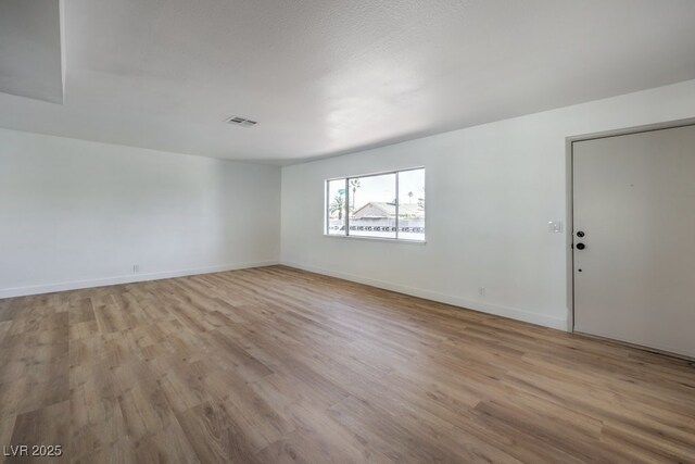 unfurnished room featuring light wood-type flooring