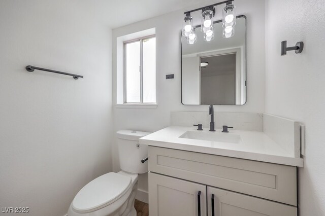 bathroom featuring toilet and vanity