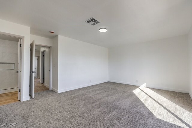 spare room featuring light colored carpet