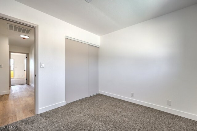 unfurnished bedroom featuring a closet and carpet