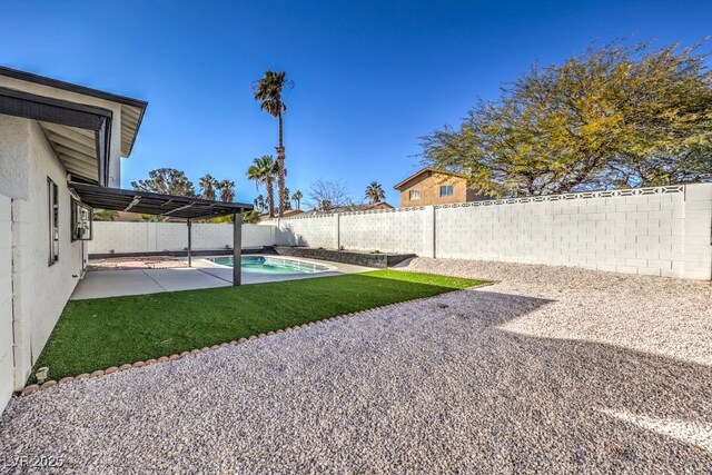 view of yard featuring a fenced in pool and a patio area