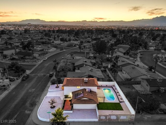 aerial view at dusk featuring a mountain view