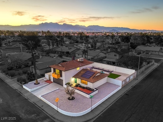 aerial view at dusk featuring a mountain view