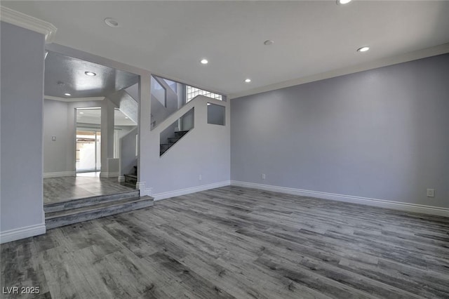 unfurnished living room with wood-type flooring and ornamental molding