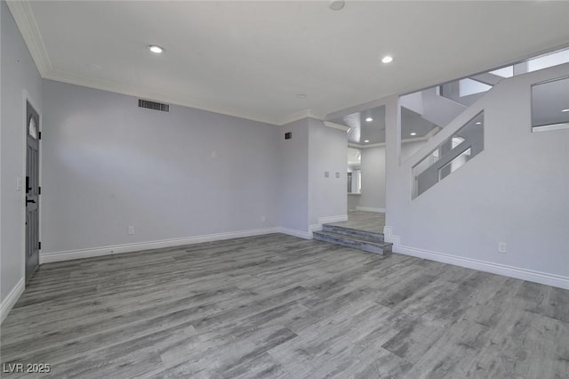 unfurnished living room featuring ornamental molding and light hardwood / wood-style flooring