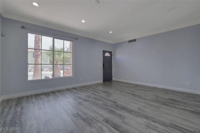 unfurnished room featuring crown molding and hardwood / wood-style floors