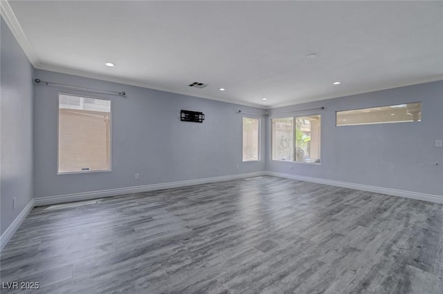 empty room with wood-type flooring and ornamental molding