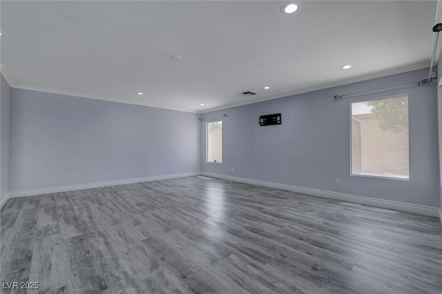 spare room featuring wood-type flooring and ornamental molding