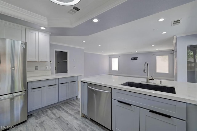 kitchen featuring light stone countertops, sink, stainless steel appliances, light hardwood / wood-style flooring, and ornamental molding