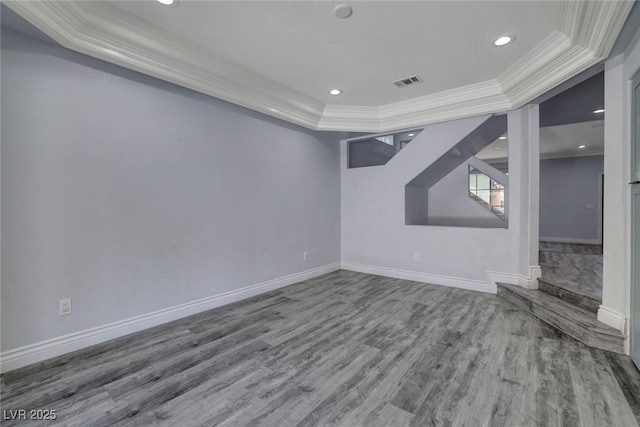 interior space featuring a tray ceiling and hardwood / wood-style flooring