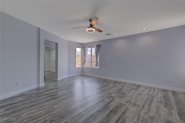 spare room featuring ceiling fan and hardwood / wood-style floors