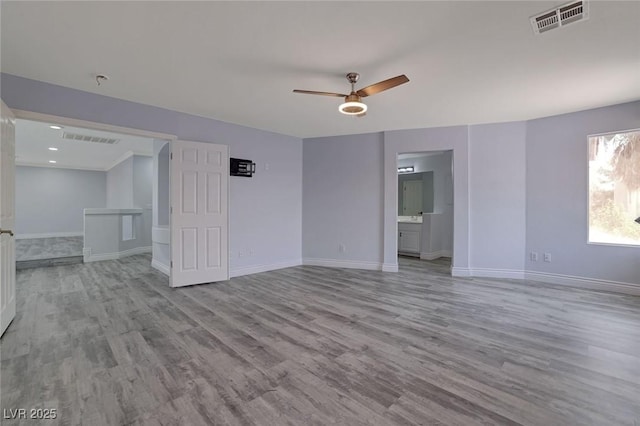 unfurnished room with ceiling fan and light wood-type flooring