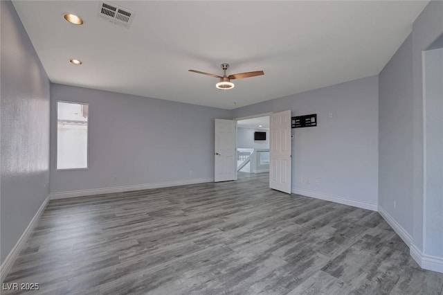 spare room with light hardwood / wood-style floors and ceiling fan