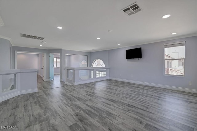 empty room with wood-type flooring and ornamental molding