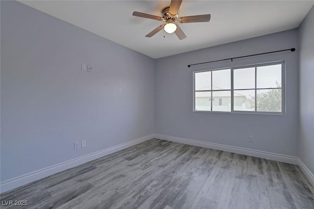 spare room featuring ceiling fan and light wood-type flooring