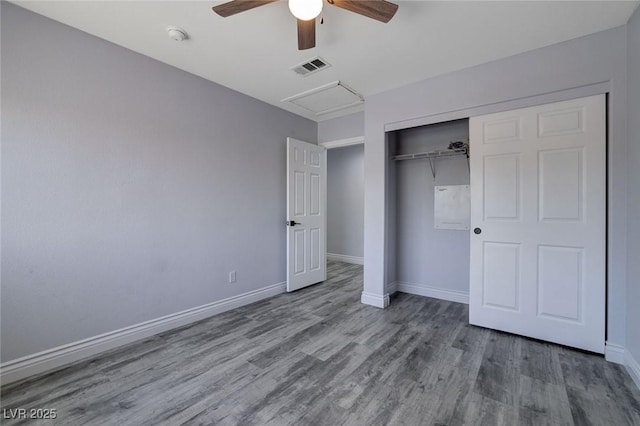 unfurnished bedroom featuring hardwood / wood-style flooring, ceiling fan, and a closet