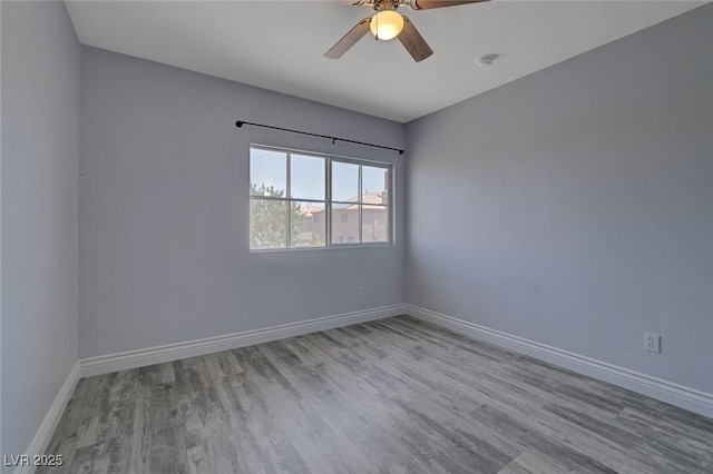 unfurnished room with ceiling fan and light wood-type flooring