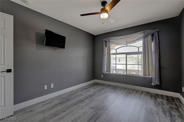 spare room featuring hardwood / wood-style floors and ceiling fan