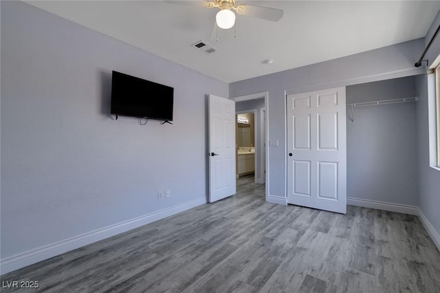 unfurnished bedroom with ceiling fan, light hardwood / wood-style flooring, and a closet