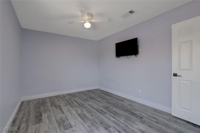 unfurnished room with ceiling fan and light wood-type flooring